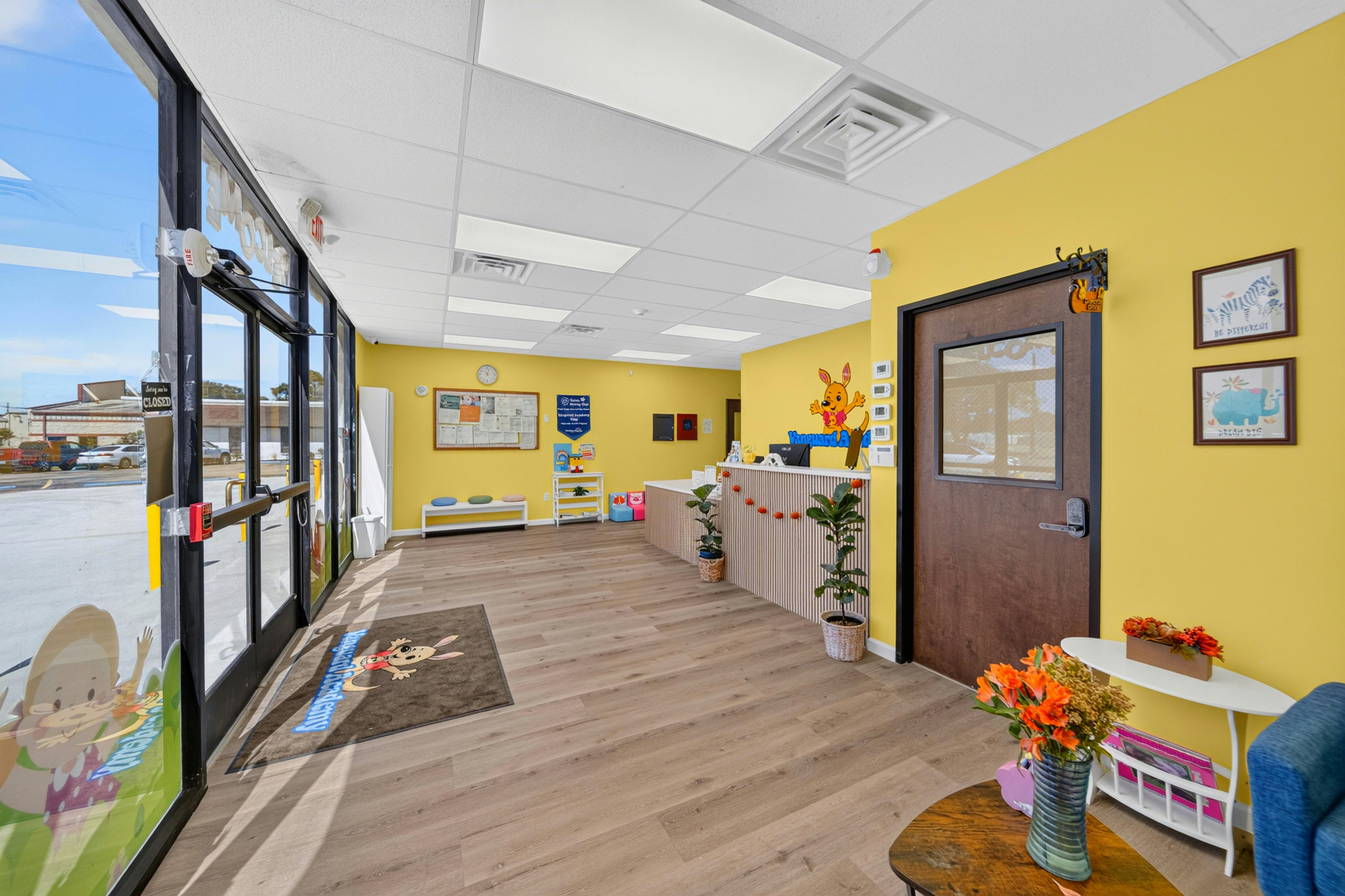 Reception area of a child care center with yellow walls and a front desk