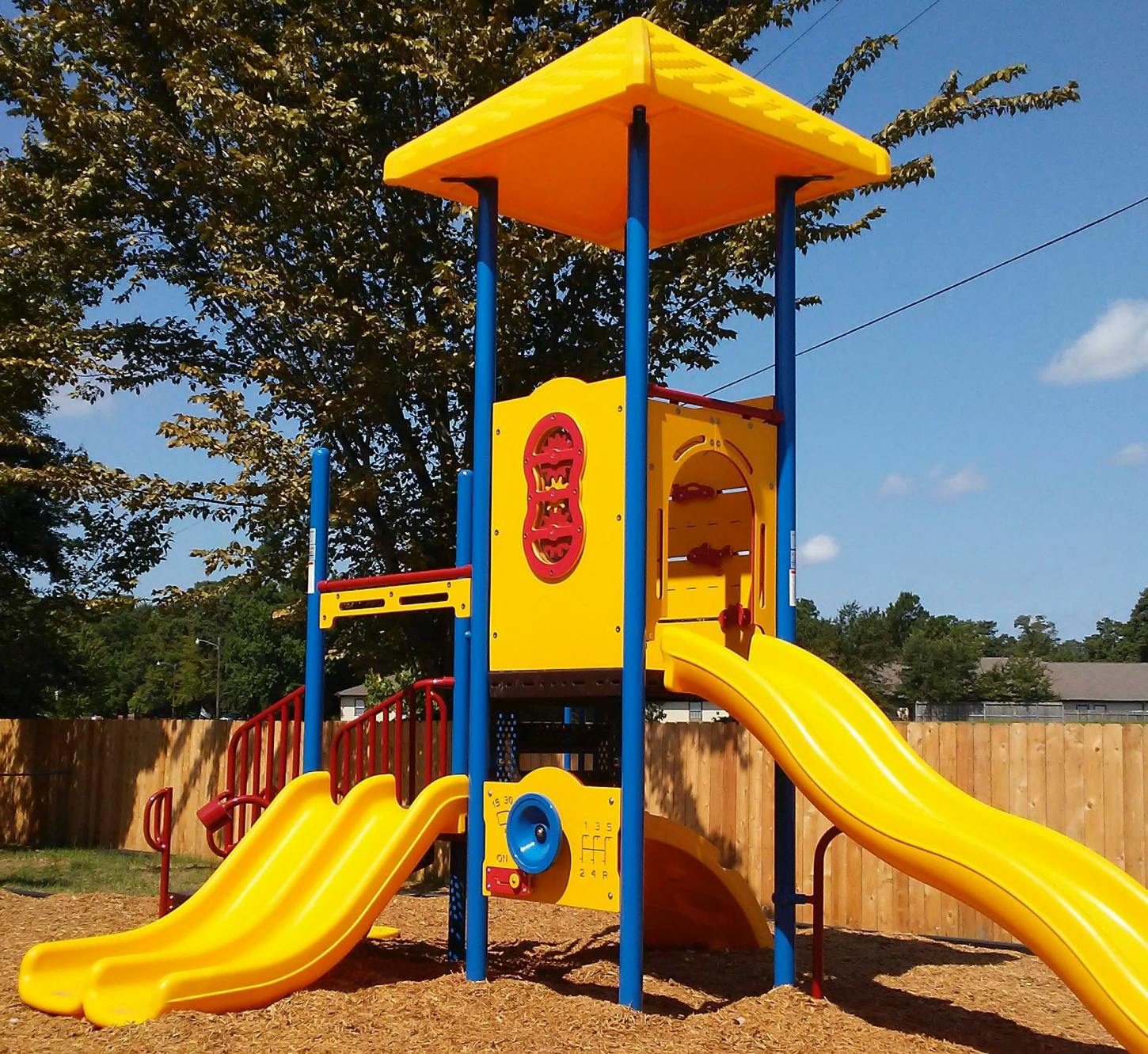 Yellow and blue playground structure with slides