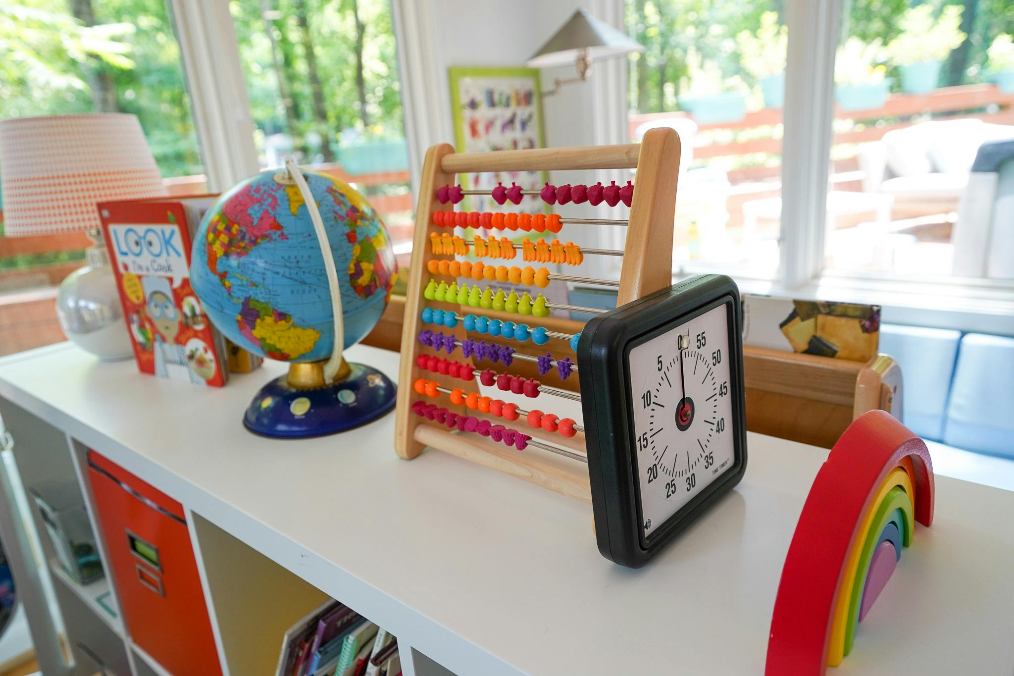 Globe, abacus, and clock on a shelf