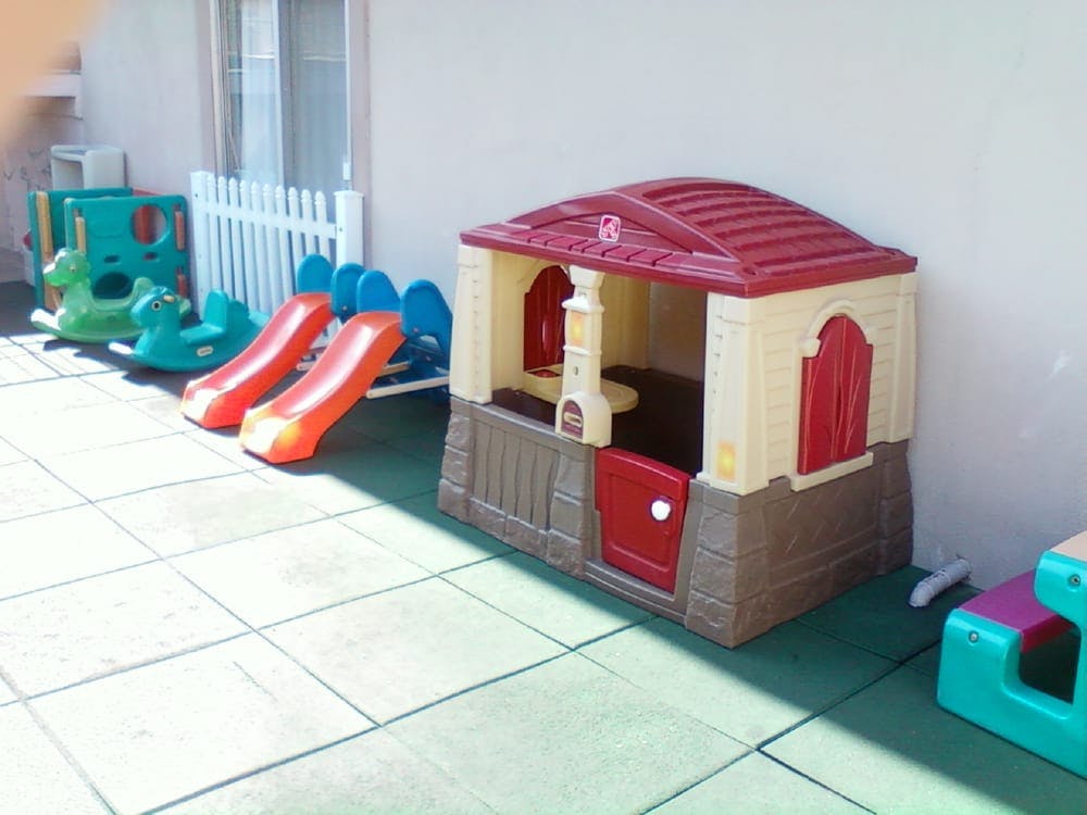 Playhouse and slides on a tiled patio