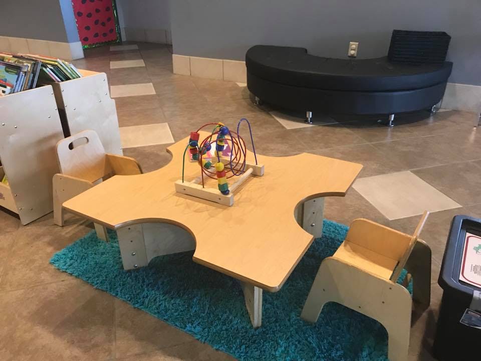 Children's table with chairs and a bead maze toy