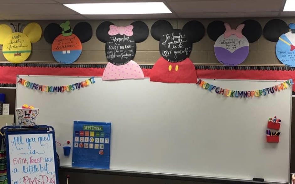 Classroom whiteboard with Mickey Mouse themed decorations above it