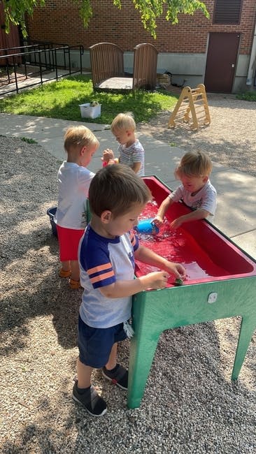 Children playing with water table outdoors