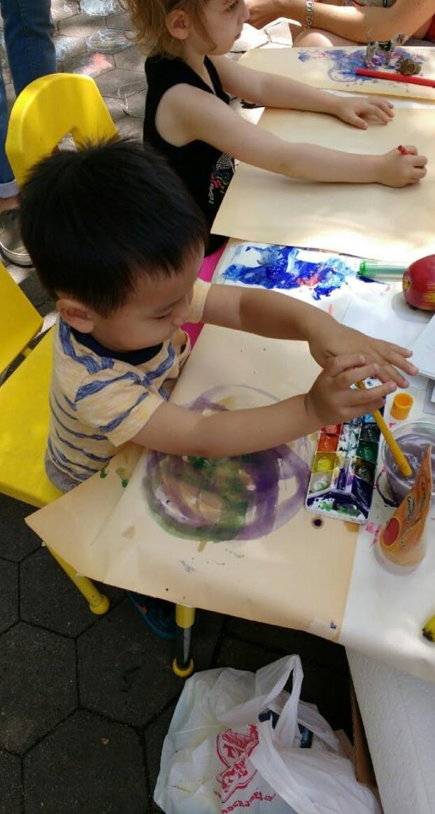 Child painting with watercolors at a table