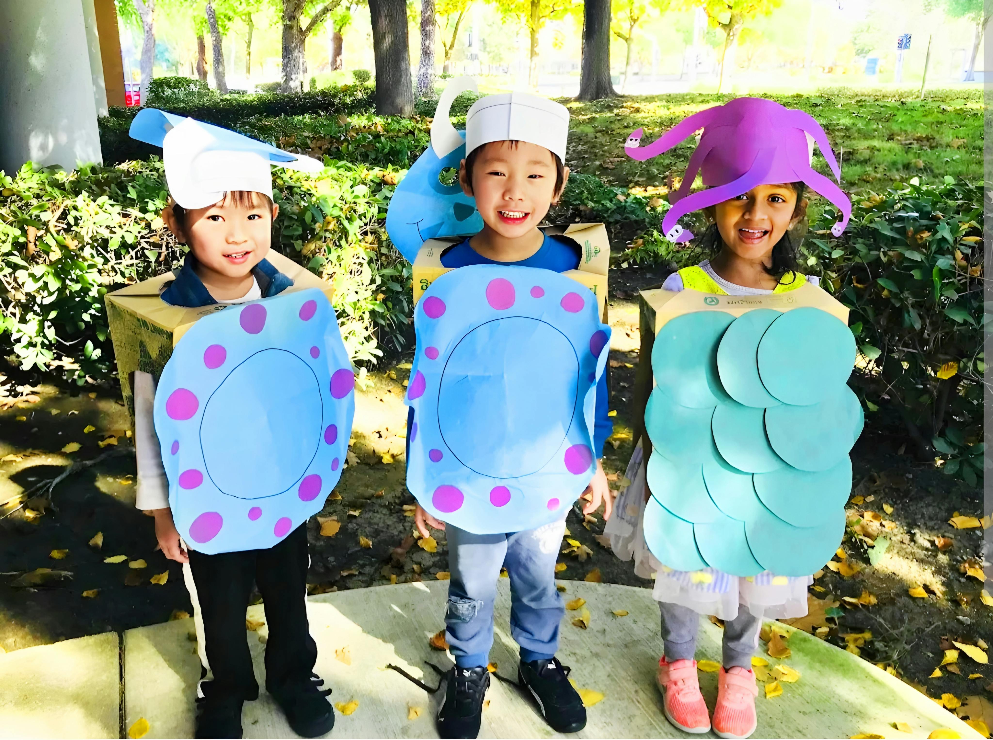 Three children in handmade costumes standing outdoors
