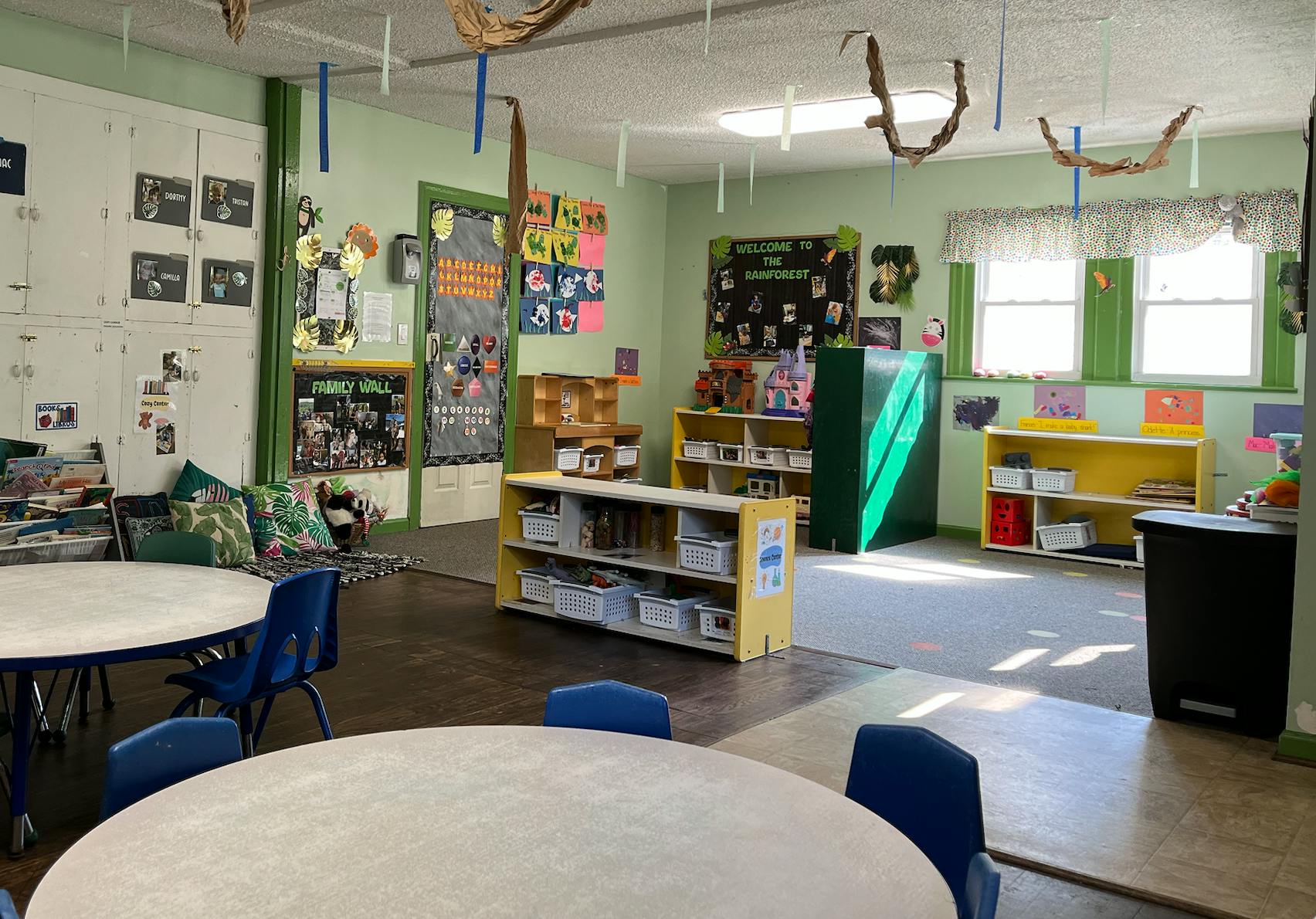 Classroom with tables, chairs, shelves, and decorations