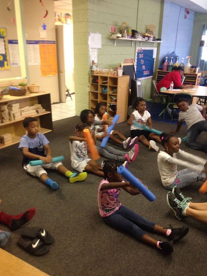 Children sitting on the floor with foam noodles