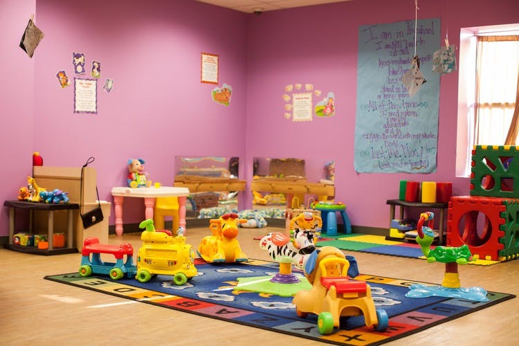 Playroom with colorful toys and a rug