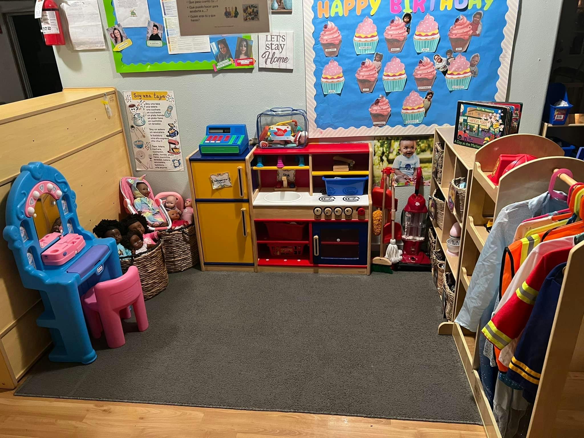 Playroom with toy kitchen, dress-up clothes, and a vanity