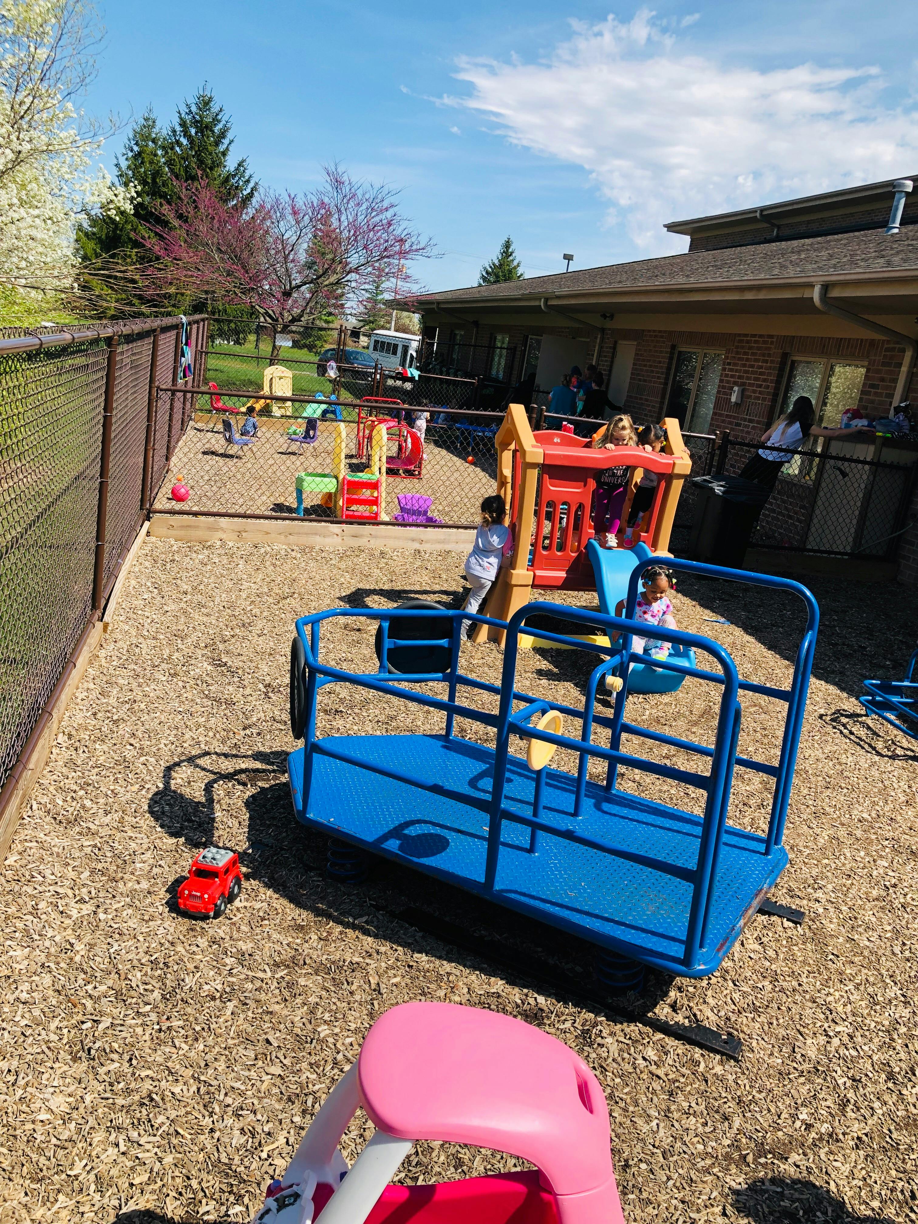 Children playing on playground equipment outdoors