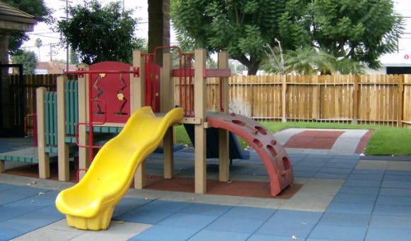 Playground with yellow slide and climbing structure