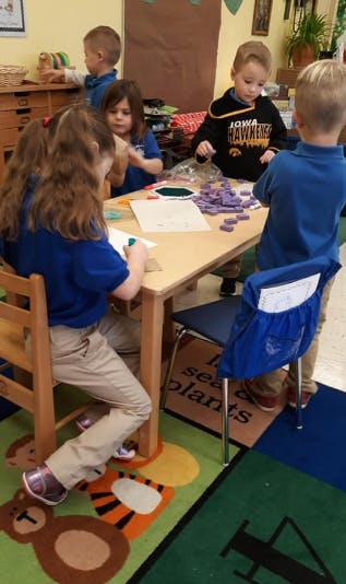 Children at a table in a classroom