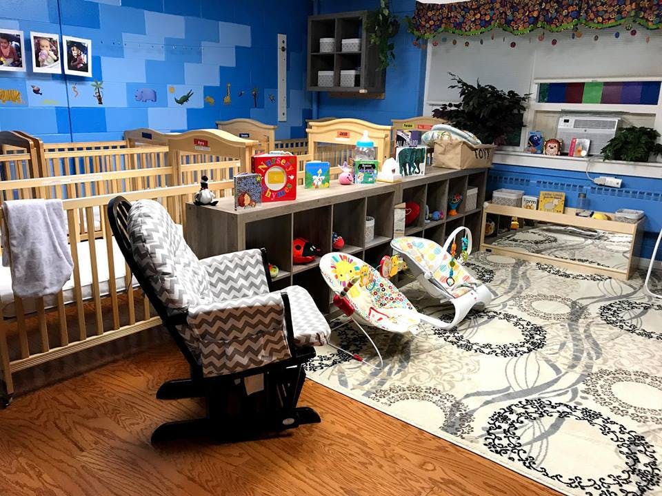 Nursery room with cribs, rocking chair, and baby bouncers