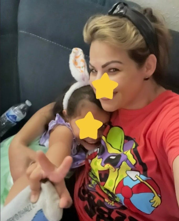 Adult person with child wearing bunny ears