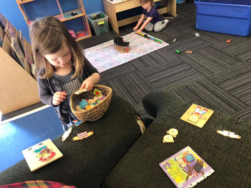 Child playing with small items in a basket