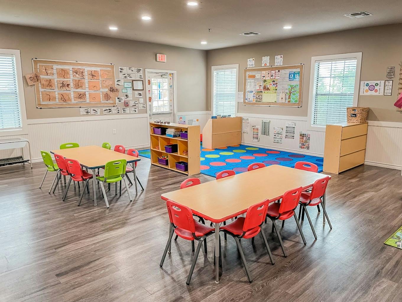 Classroom interior with tables, small chairs, and educational wall displays