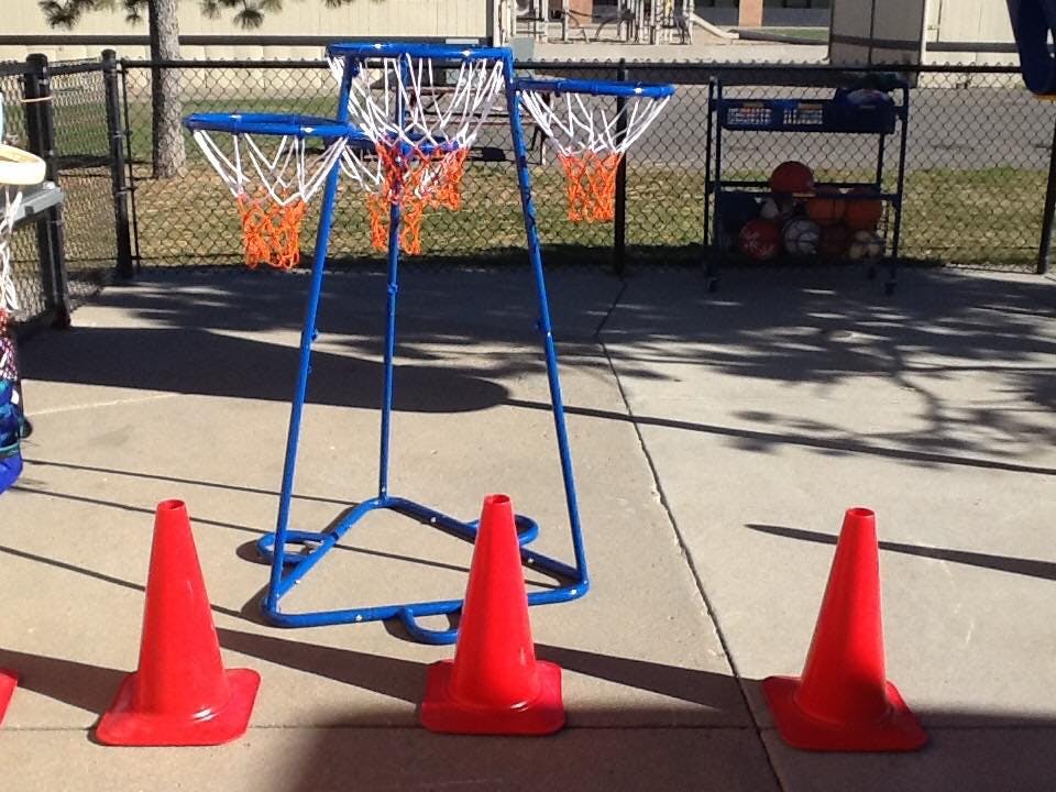 Basketball hoops with orange cones on concrete