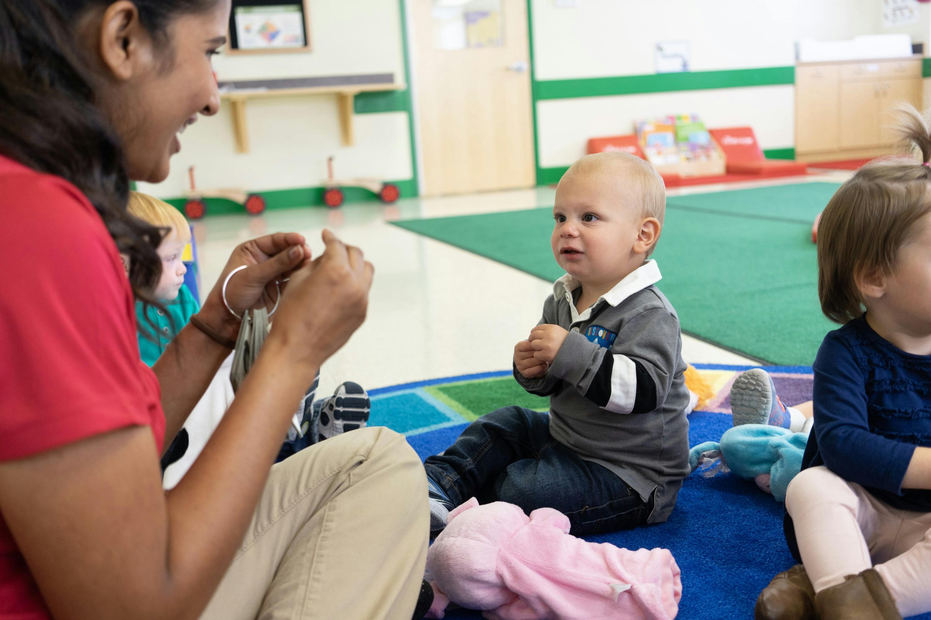 Person interacting with a child in a classroom
