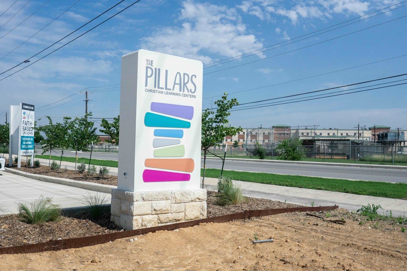 Sign for The Pillars Christian Learning Centers near a roadside