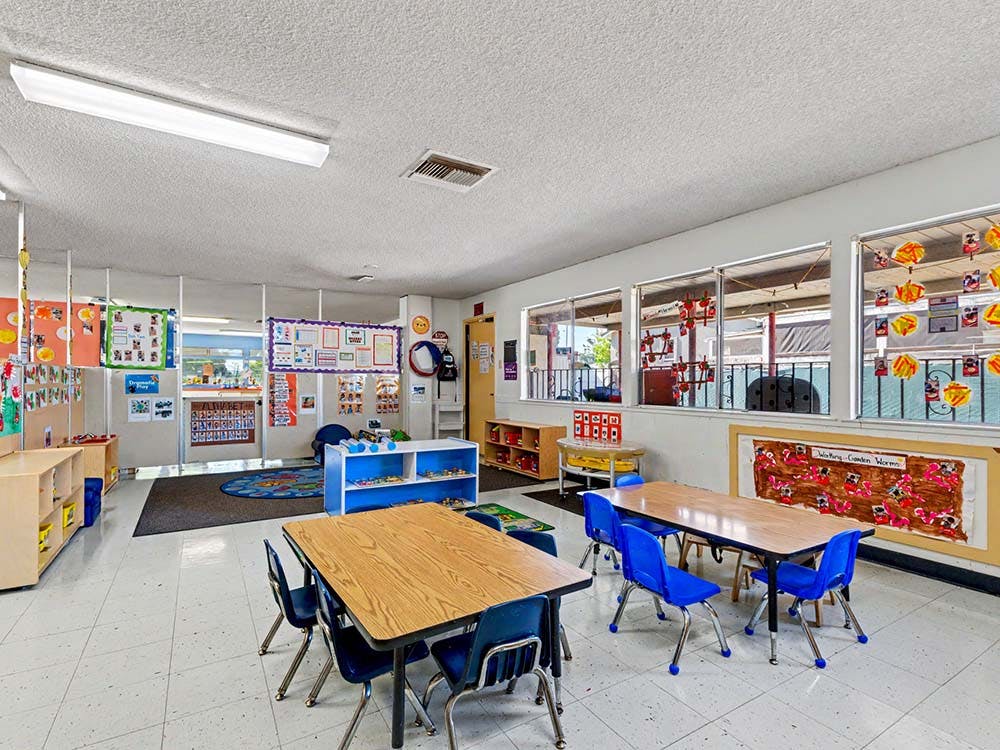 Classroom with small tables and chairs, and colorful decorations