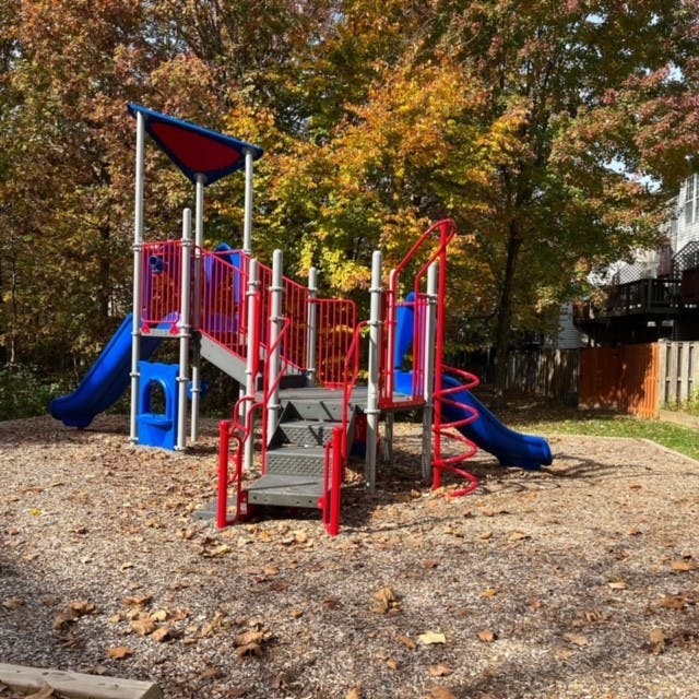 Playground structure with slides and stairs