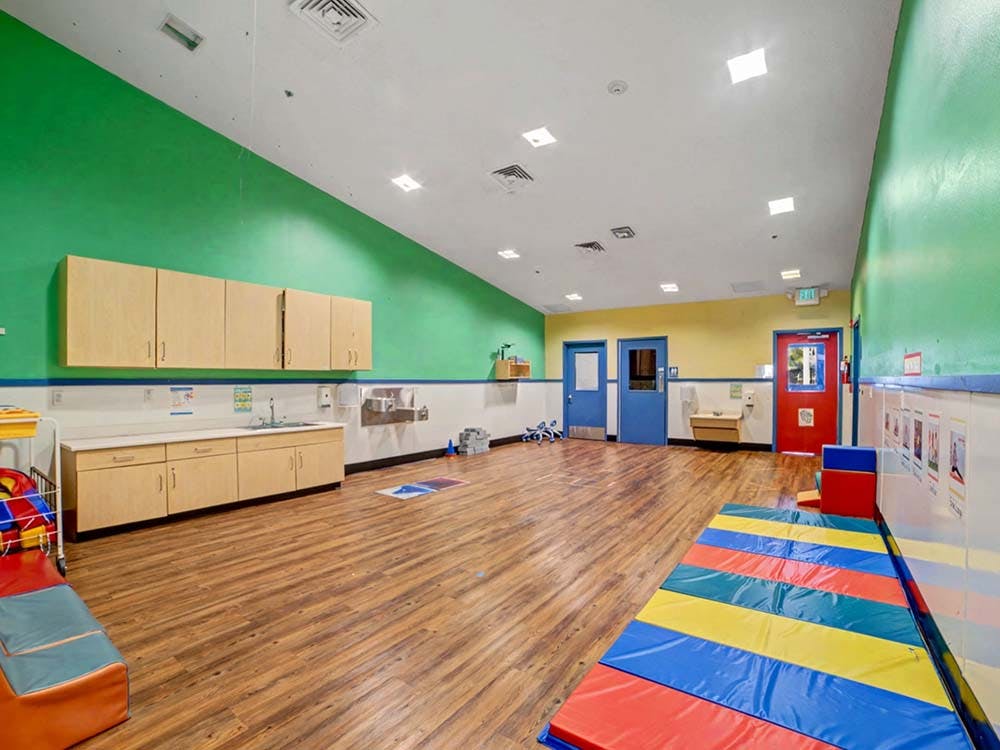 Empty classroom with colorful walls and a sink