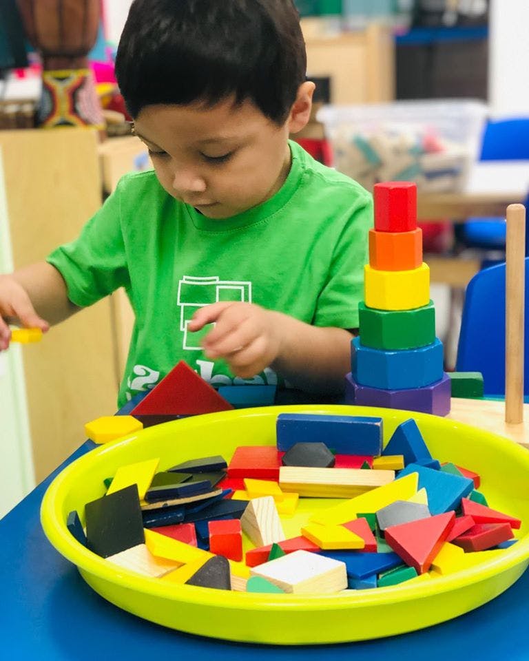 Child playing with colorful building blocks