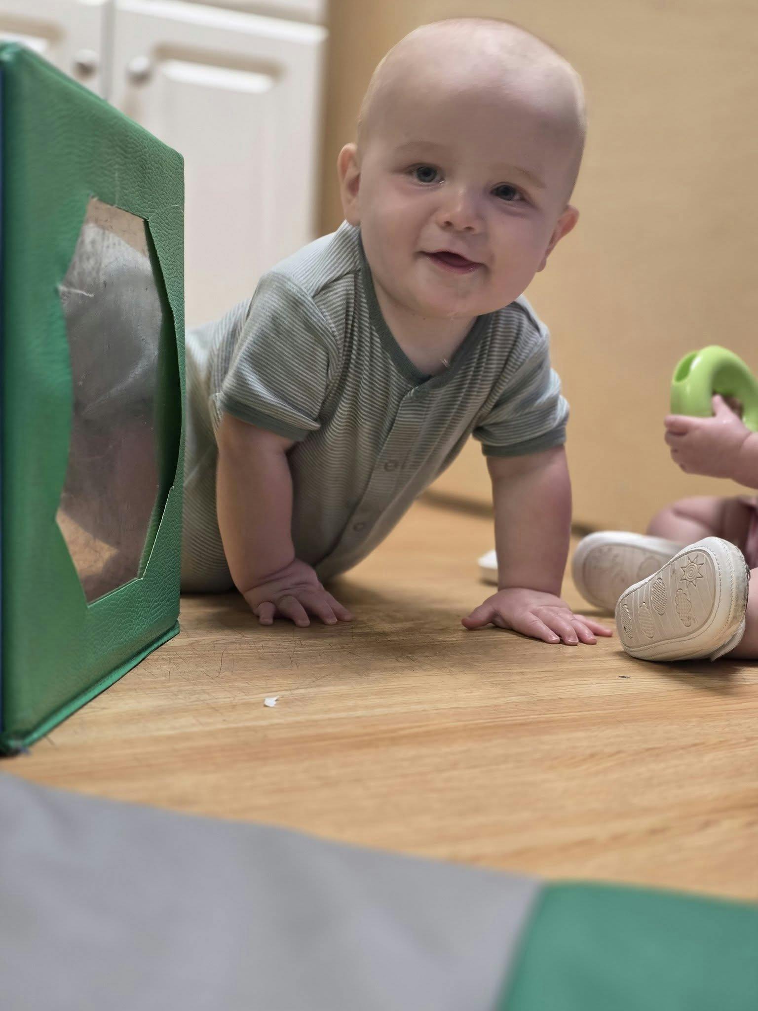 Child crawling on a wooden floor
