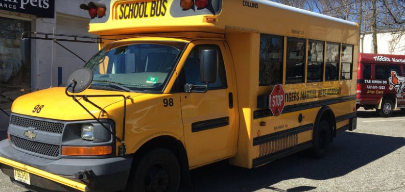 Yellow school bus with "SCHOOL BUS" text on top