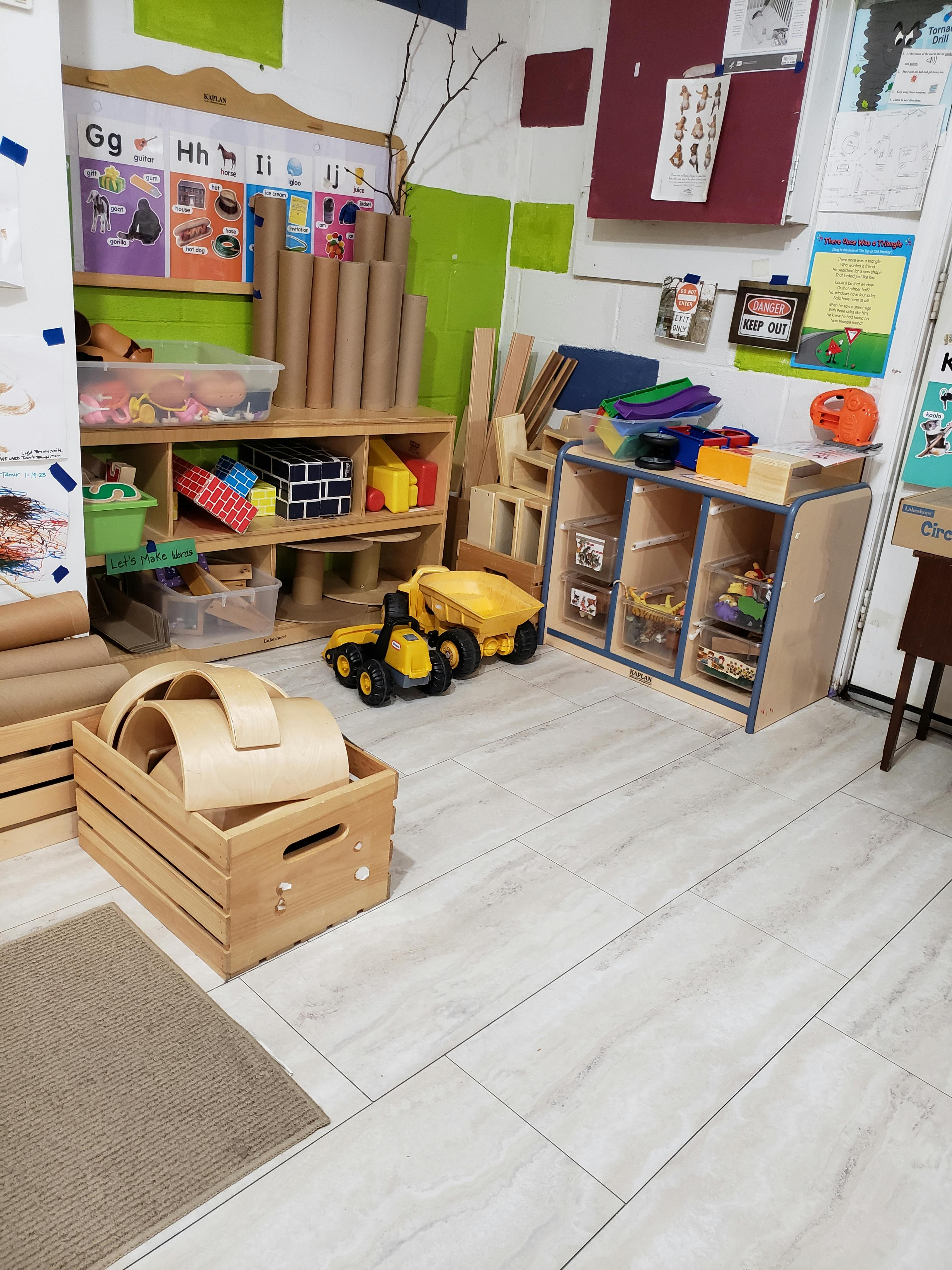 Classroom with shelves of toys, building blocks, and construction vehicles