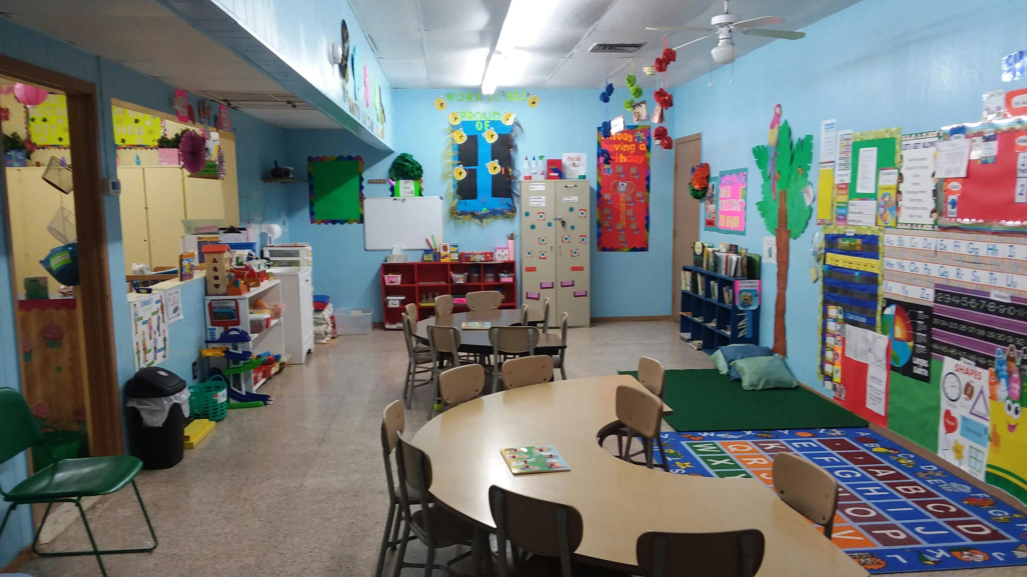 Classroom with tables, chairs, and colorful decorations