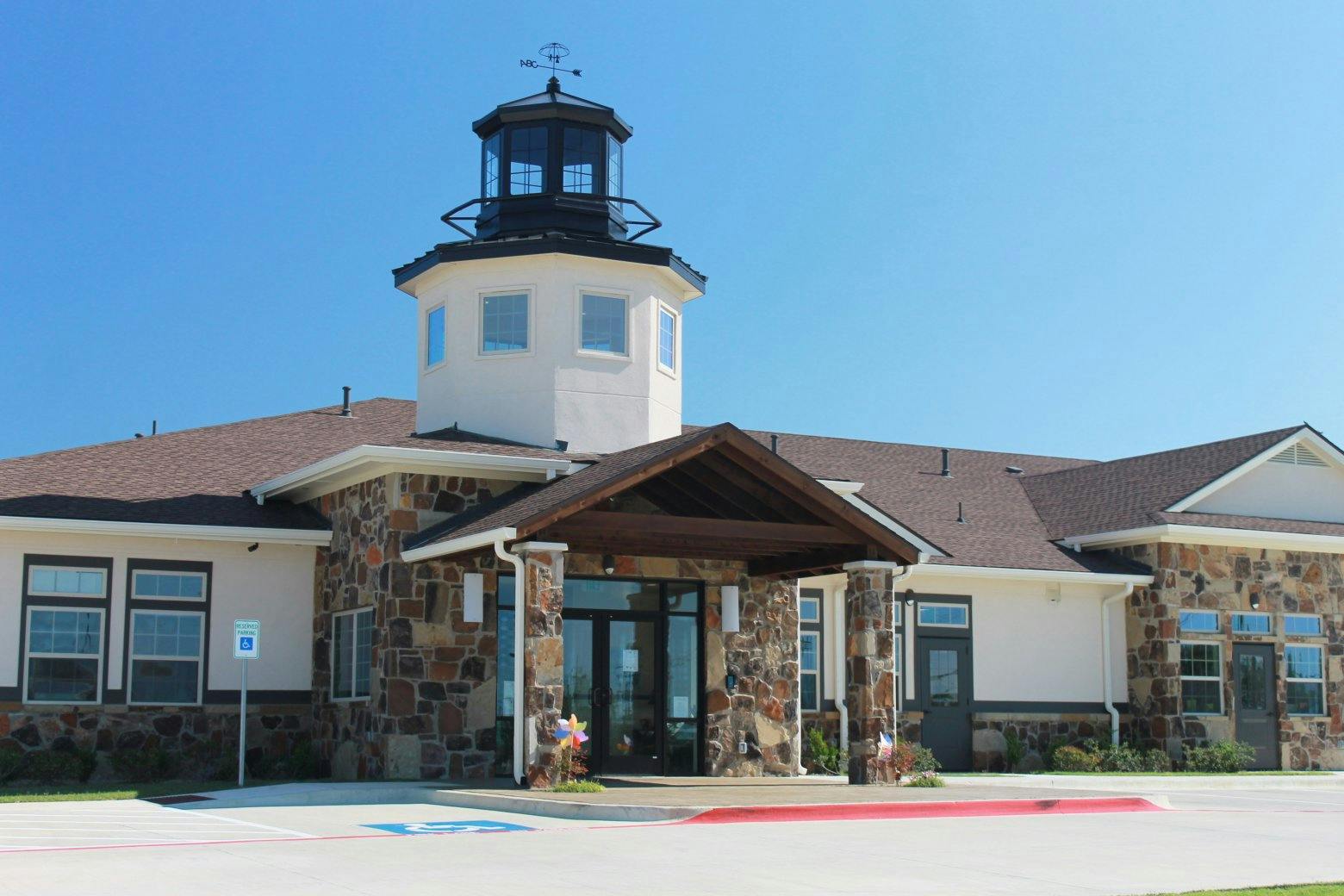 Building with a lighthouse-style tower and stone facade