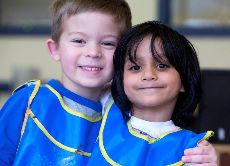 Two children in blue smocks