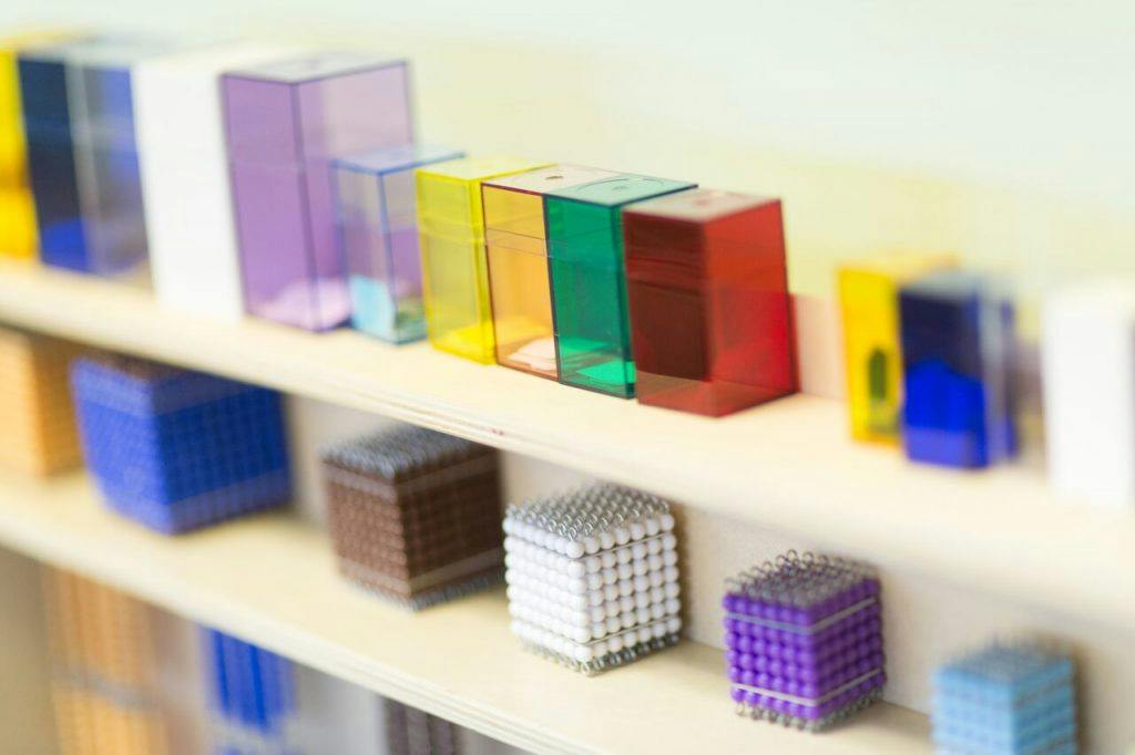 Colorful translucent blocks and textured cubes on shelves