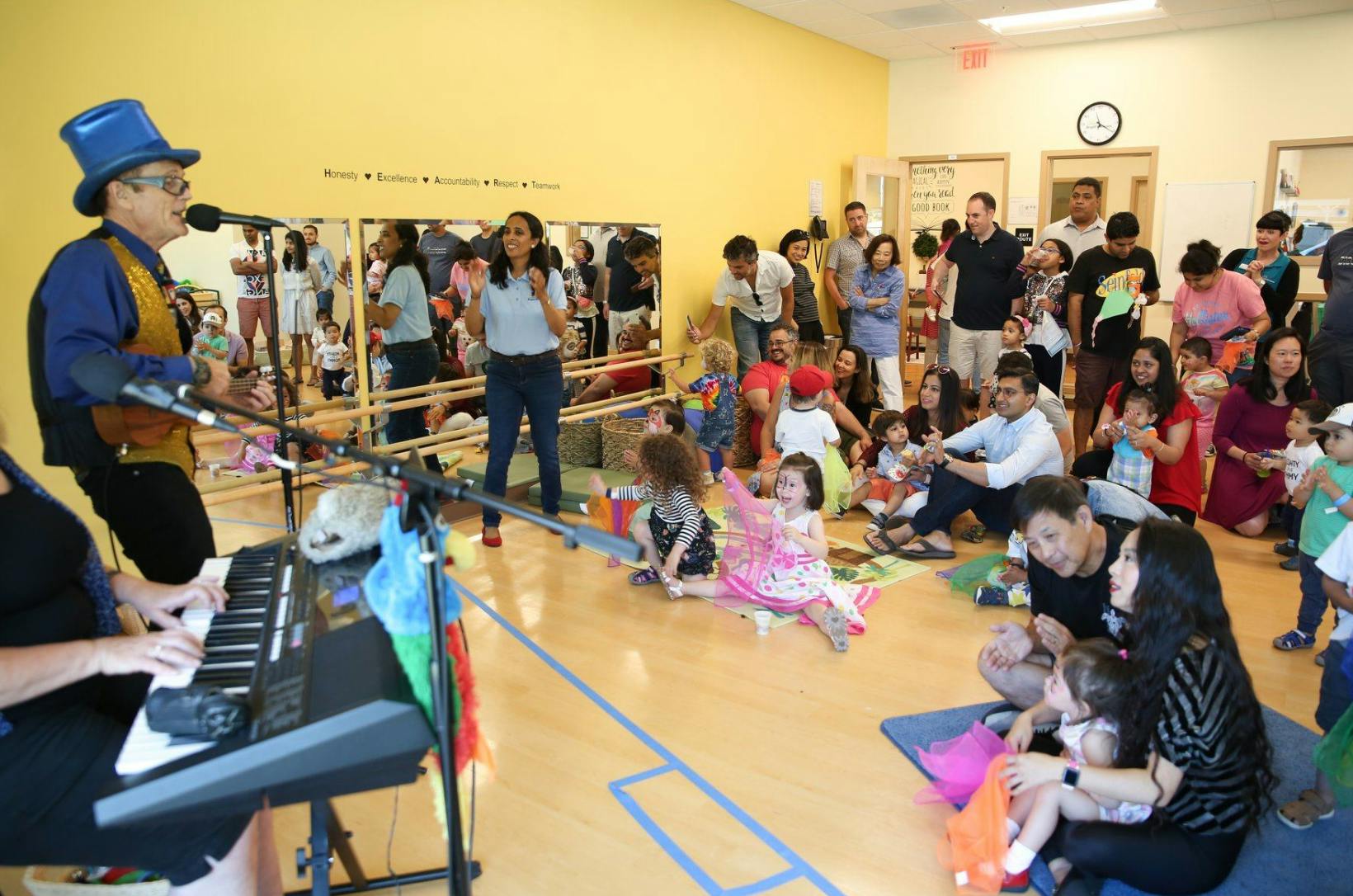 People performing music for an audience of adults and children