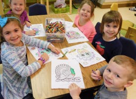 Children coloring at a table