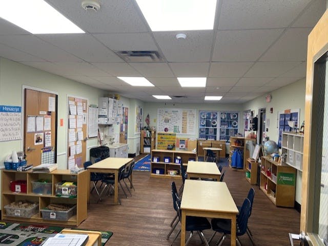 Empty classroom with small tables and chairs