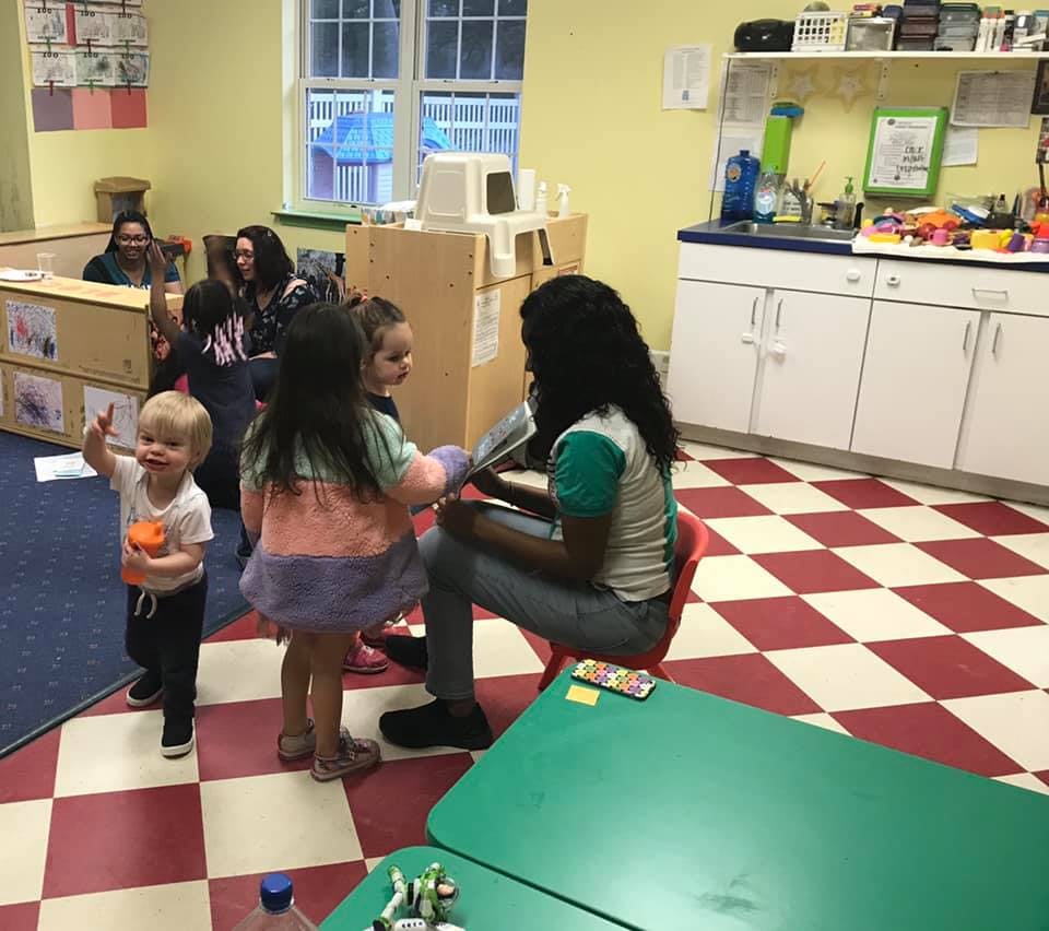 Adult reading to children in a classroom