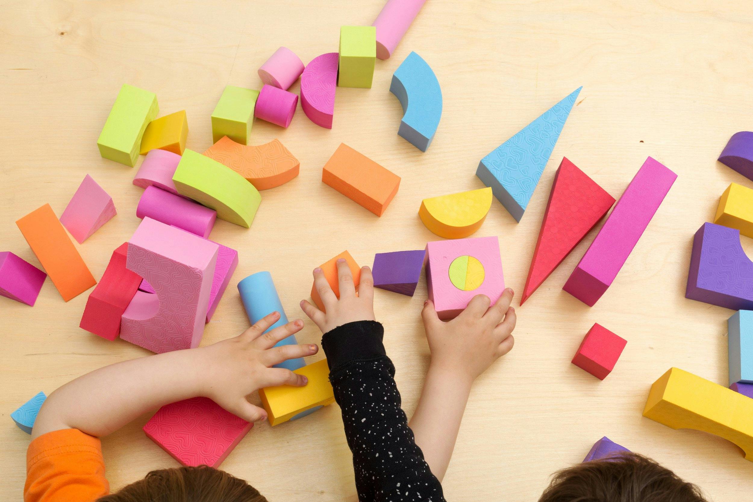 Children playing with colorful foam building blocks