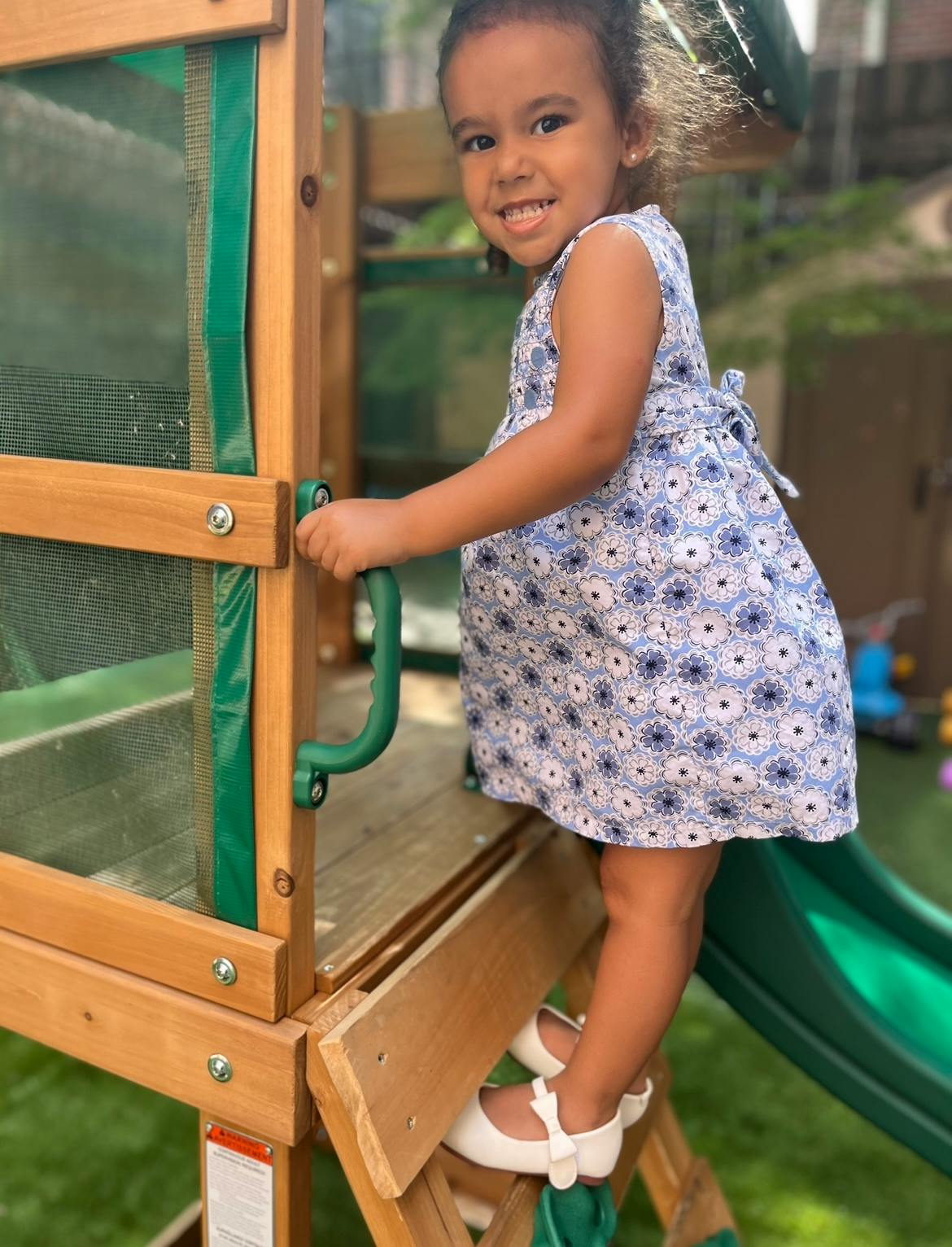 Child climbing on a wooden playset