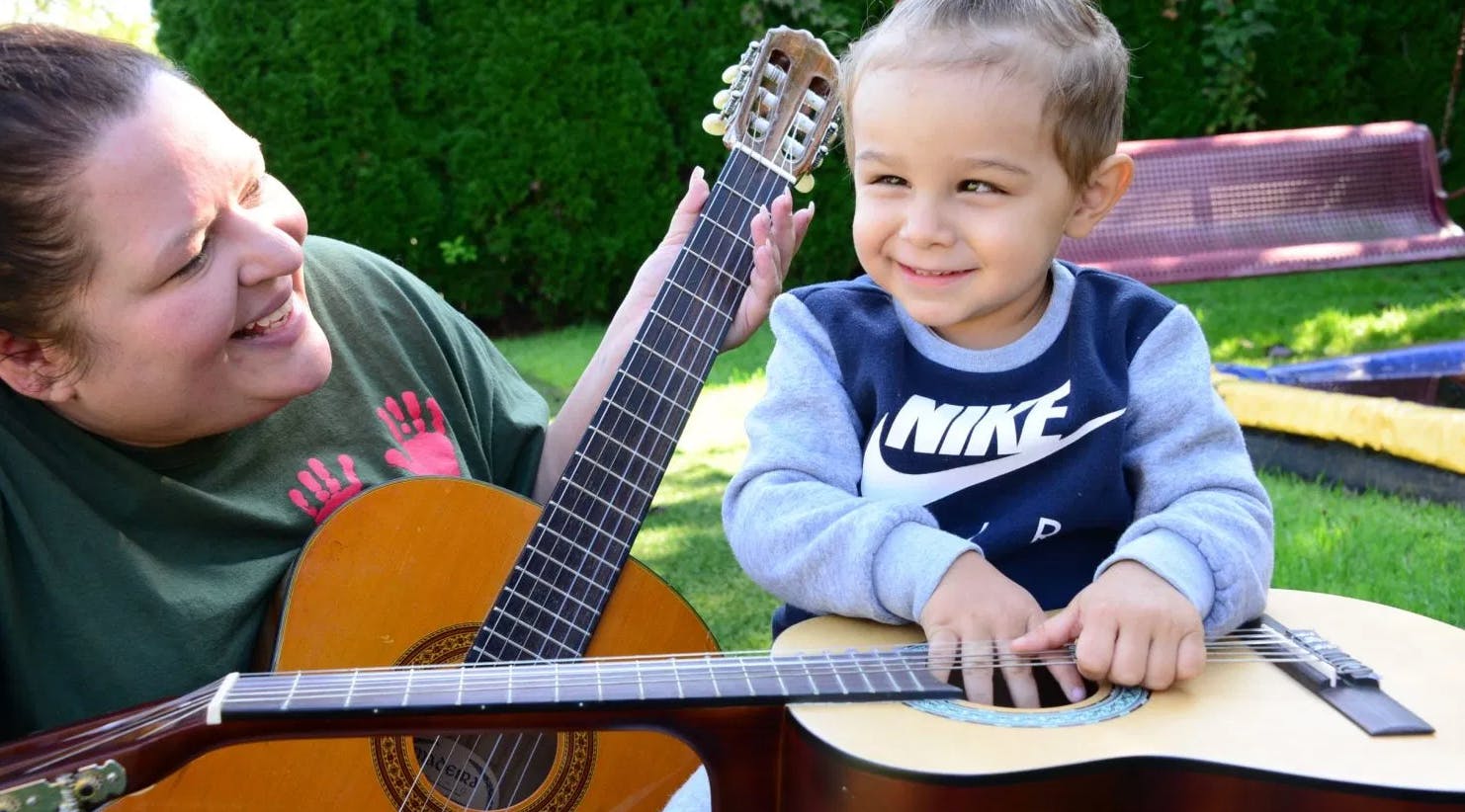 Person and child with guitars