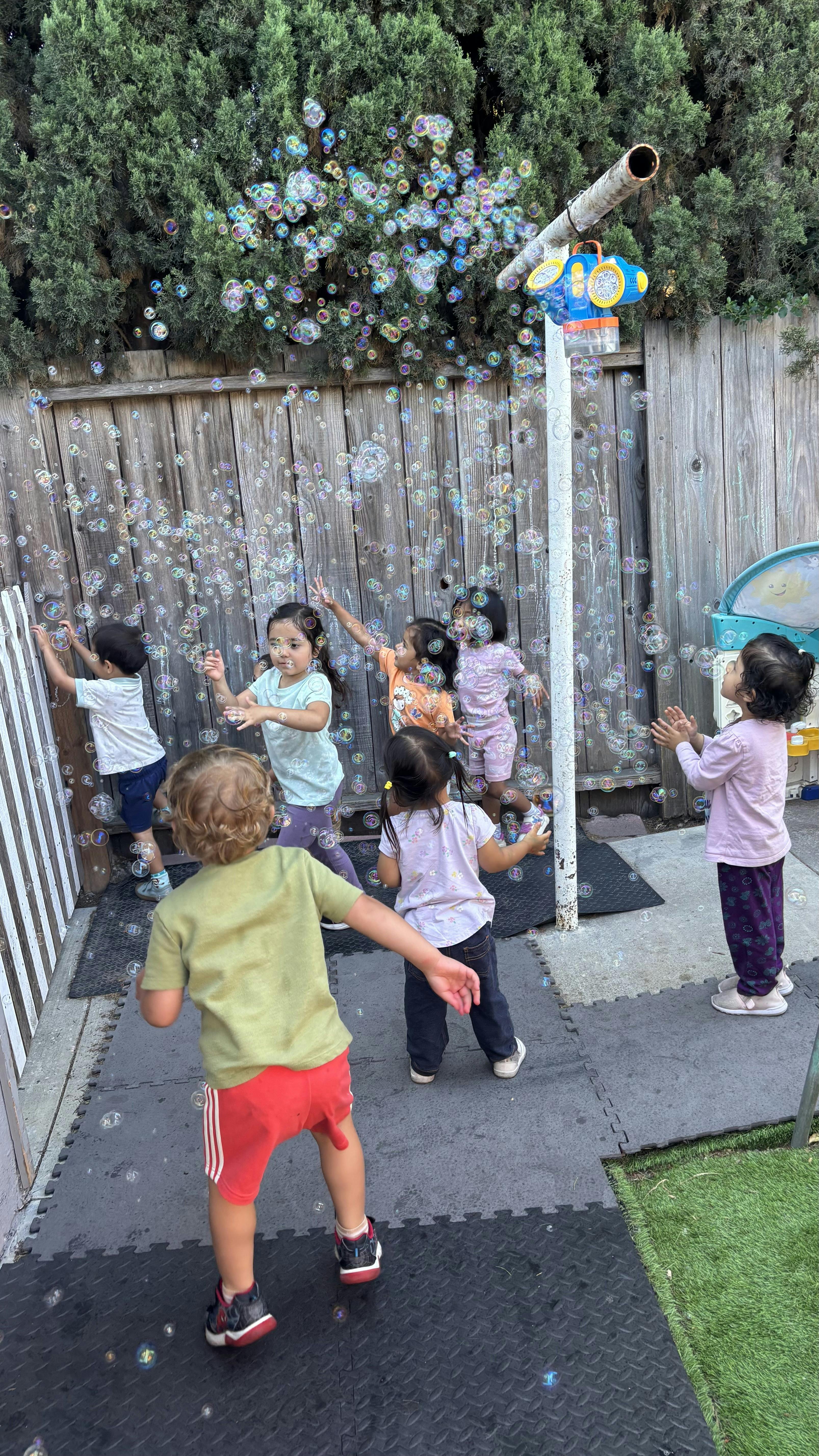 Children playing with bubbles outdoors