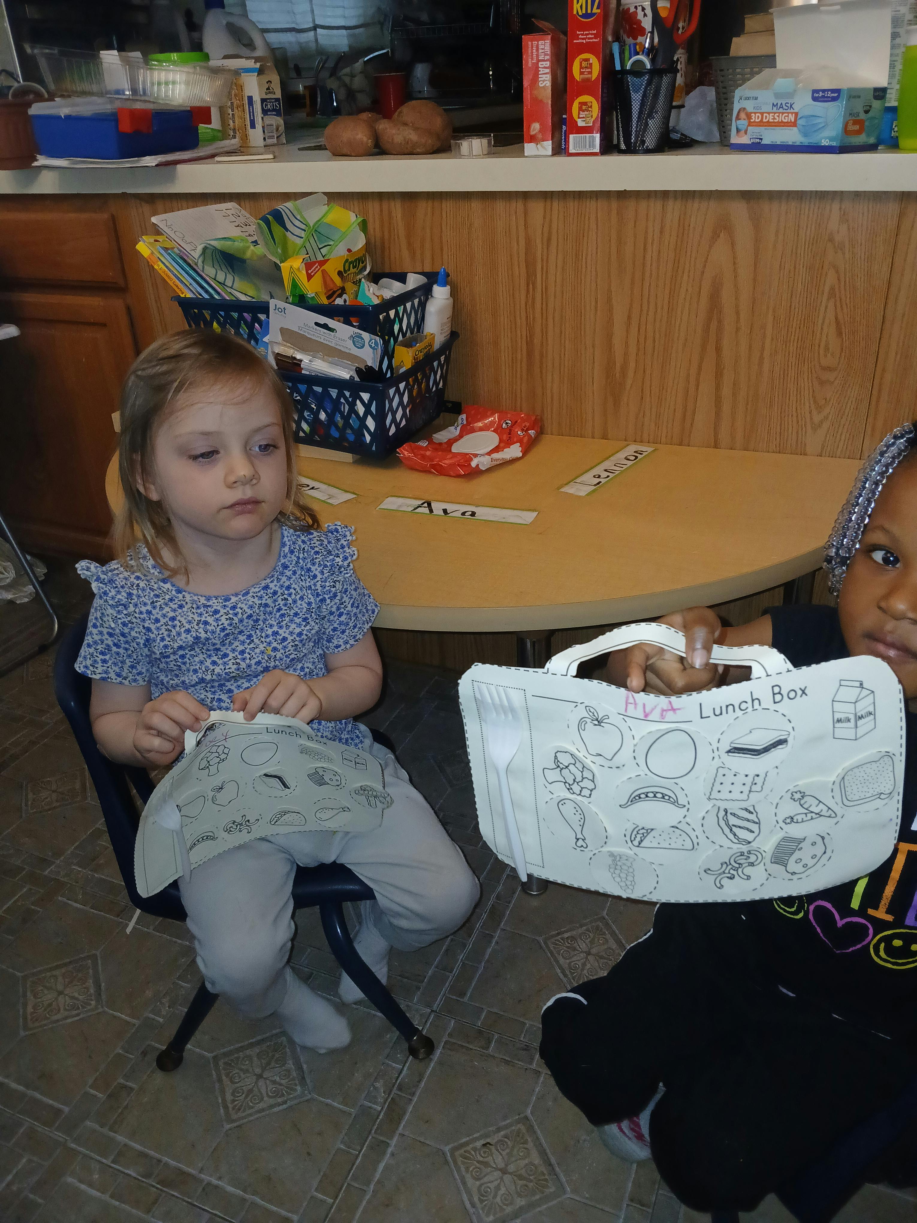 Two children with a lunch box craft
