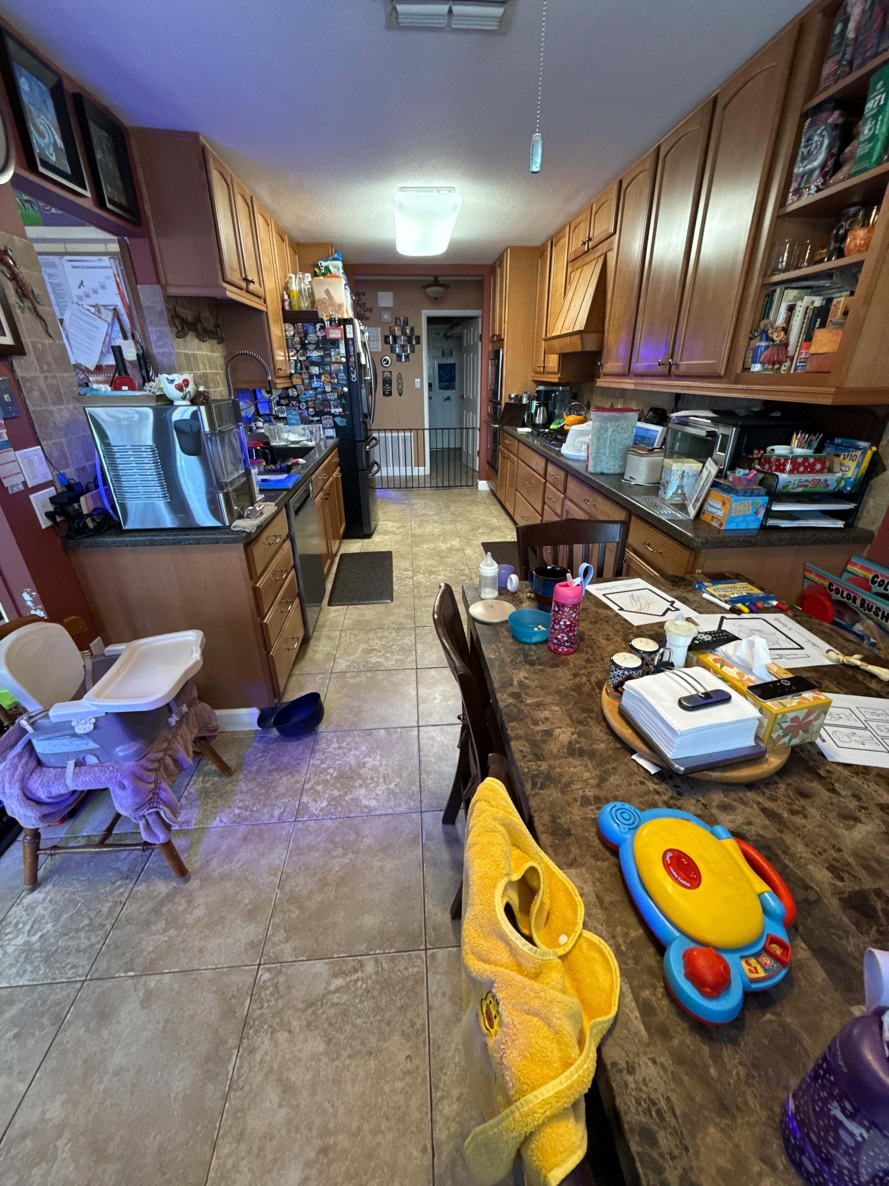 Kitchen counter covered with children toys and items
