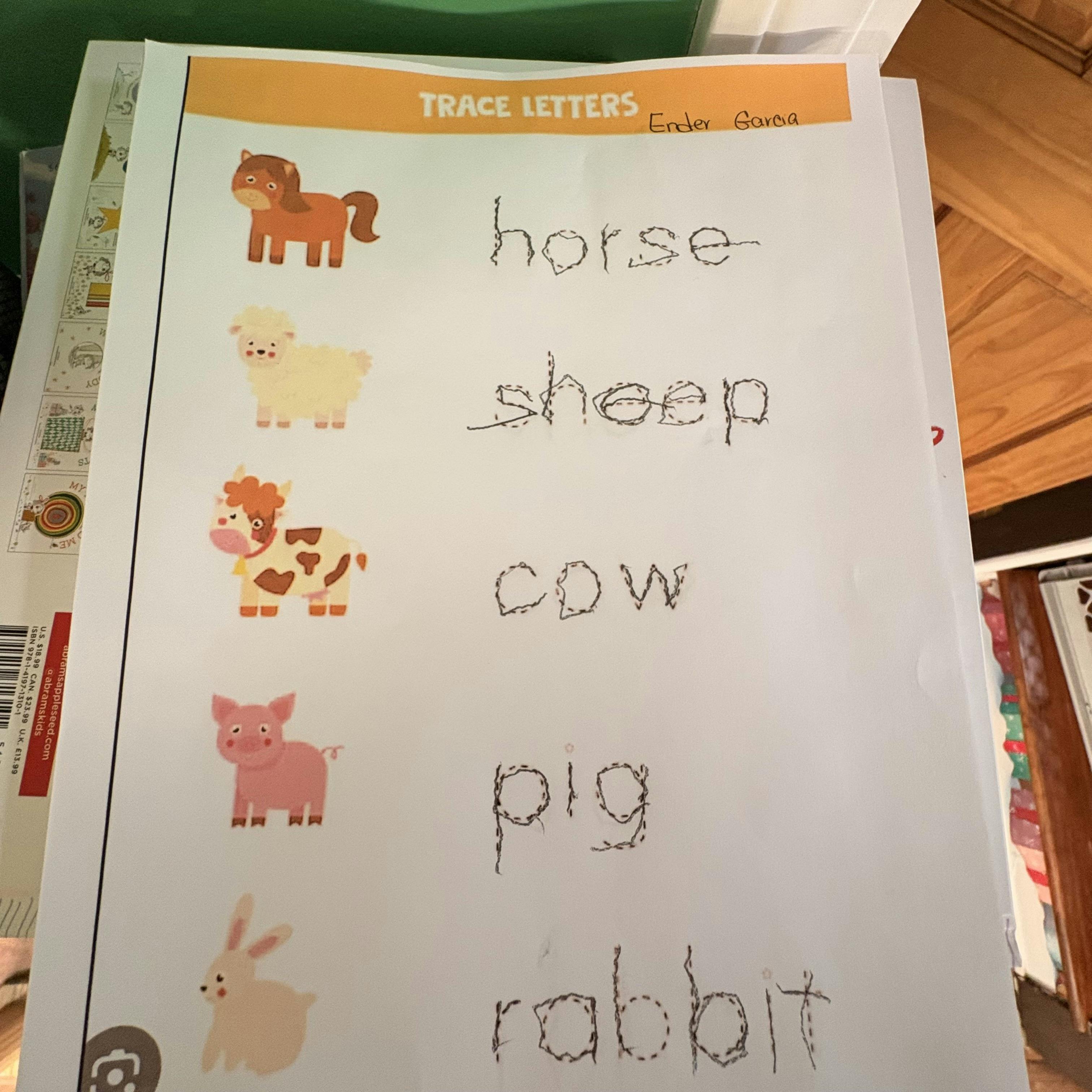 Child's handwriting practice sheet with farm animals