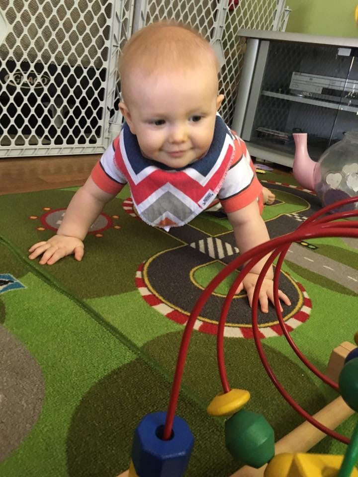 Child crawling on a rug