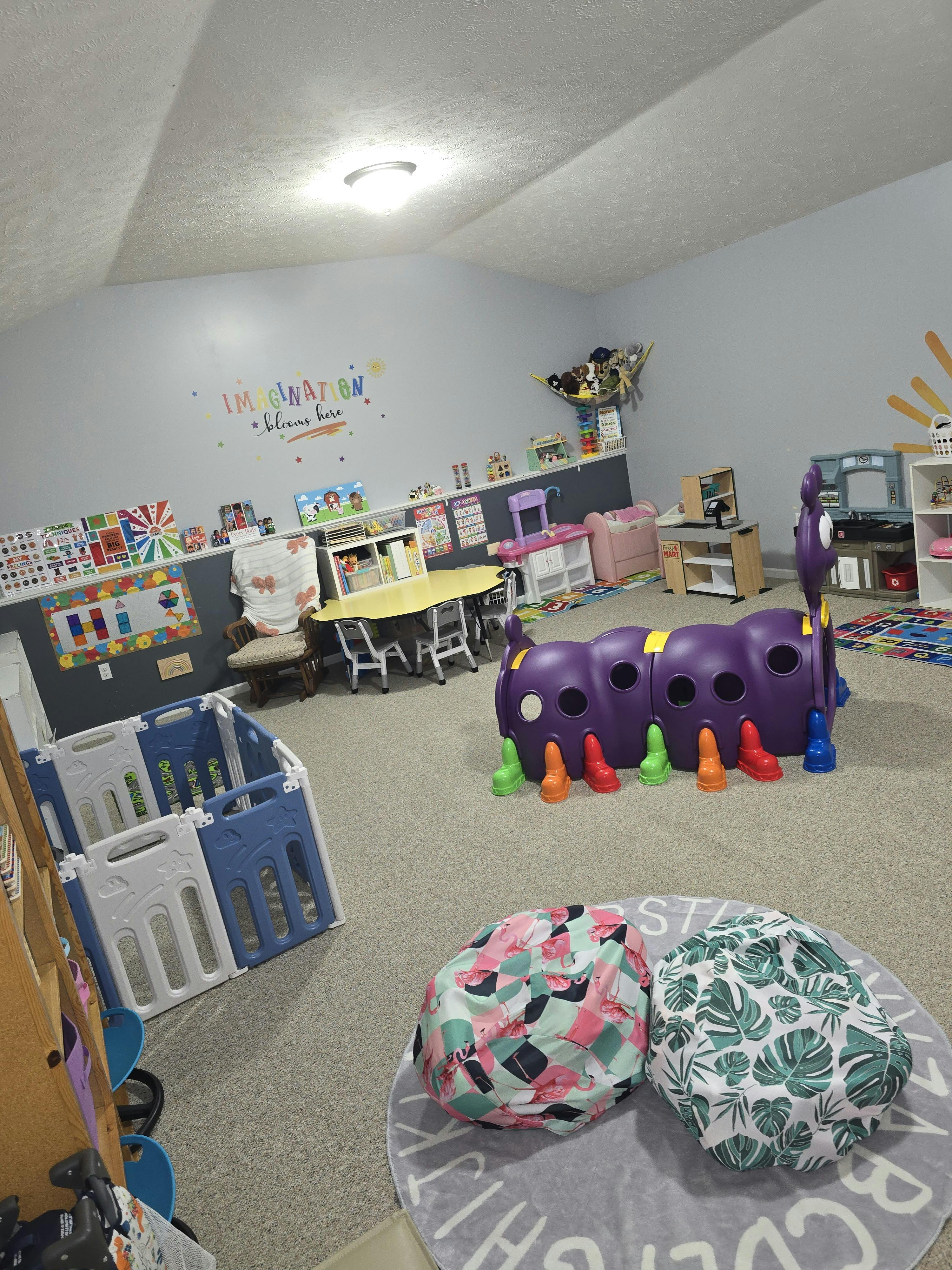 Playroom with a tunnel toy, child-sized furniture, and play sets