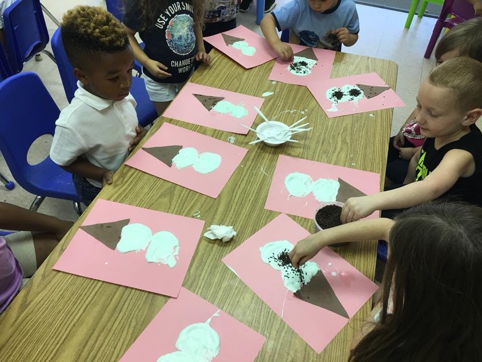 Children making ice cream cone crafts at a table