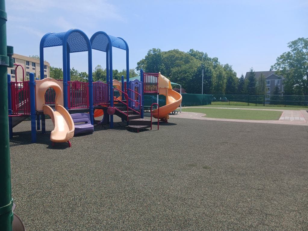 Colorful empty playground with multiple slides and structures