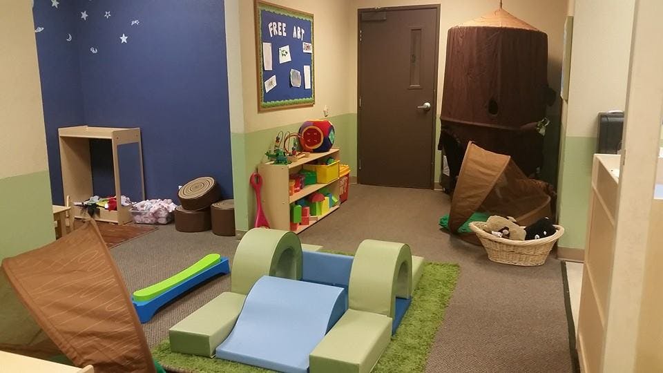 Playroom with soft play equipment and shelves of shelves with toys
